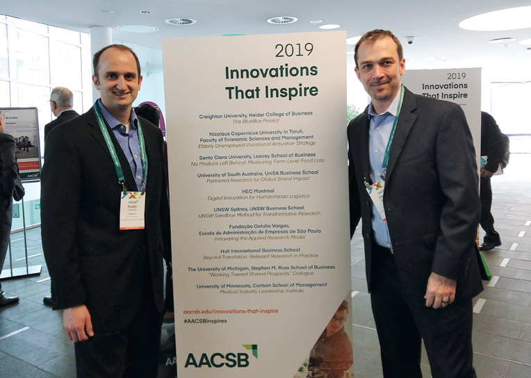 Charles Braymen and Dustin Ormond standing with an "Innovations that Inspire" banner