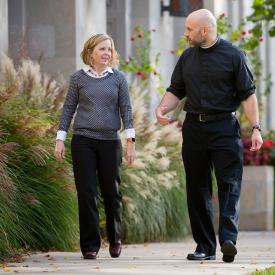 Catholic priest talking with person 