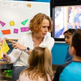 Teacher reading to a group of young children