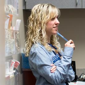 Nursing student talking to other students in exam room