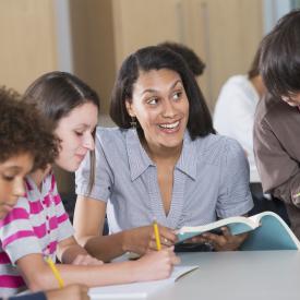 teacher working with several students