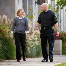 Catholic priest talking with person