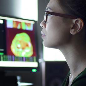 Person reviewing medical scans on a computer