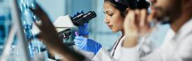 Person at a microscope working in a lab